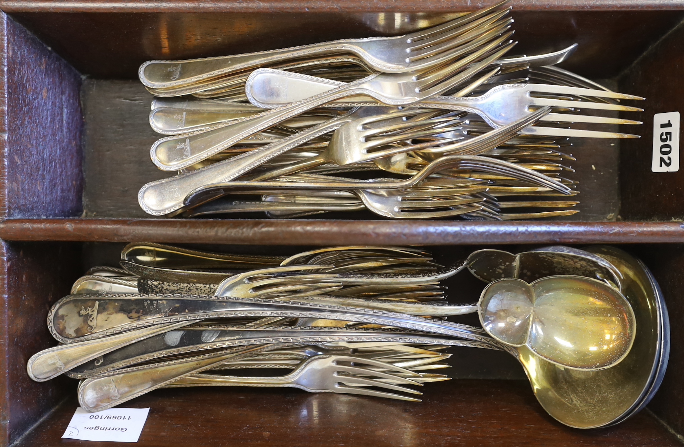 An Elkington & Co. plated canteen of cutlery, each piece engraved with a greyhound crest and two mahogany cutlery boxes